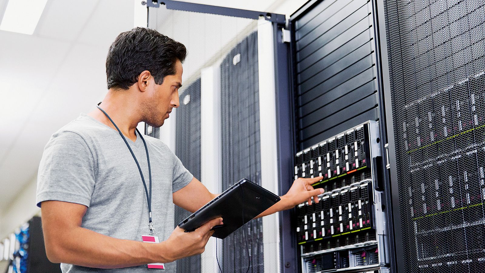 A technician stands in front of a control cabinet